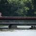 Pedestrians walk along a railroad bridge after watching Washtenaw County Sheriff members and dive team search Huron River for the body of 21-year-old Pittsfield Township man on Sunday, June 30. Daniel Brenner I AnnArbor.com